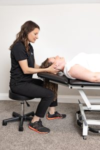 A Physiotherapist uses manual therapy to help a patients neck